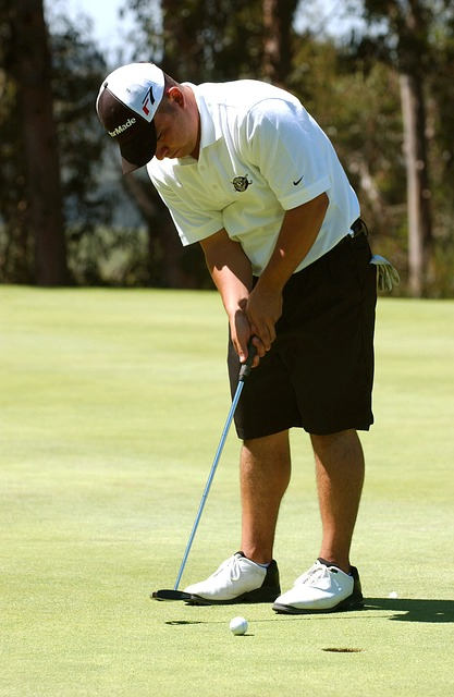 muž, ktorý hrá golf